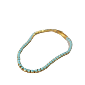 Elegant gold tennis bracelet featuring round light blue turquoise stones in a prong setting