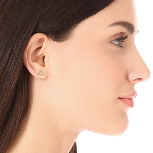 Elegant white shell clover flower stud earrings with gold plating on model side profile