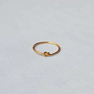 Minimalist handmade gold-plated brass sailor knot ring with sleek circular design