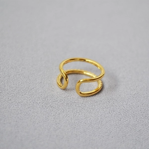 Close-up of a double-layered gold-plated brass ring with sparkling cubic zirconia stones