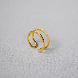 Macro detail of gold plated double layer ring with sparkling cubic zirconia pavé setting