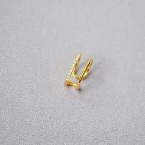 Detail of gold-plated double-band ring with pavé-set sparkling cubic zirconia
