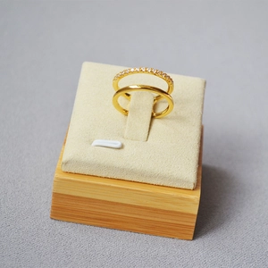 Detail of double-layer gold ring featuring a sparkling zircon band and smooth metal finish