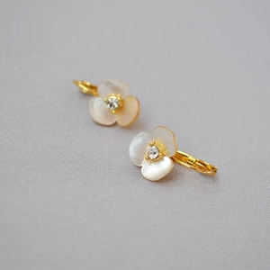 Detail of clover earring with white mother of pearl petals and crystal center