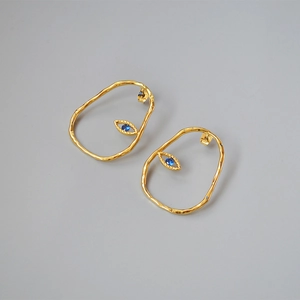 Abstract irregular gold earrings with blue center stones, minimalist retro style