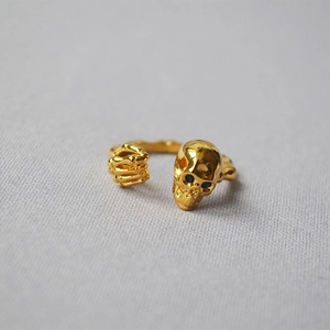 Punk style 18K gold-plated open ring featuring a realistic skull and skeletal hand design