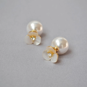Macro detail of white shell clover earrings with pearl backing and crystal center