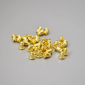 Golden bullet-shaped earring backs made of copper with non-slip silicone interior