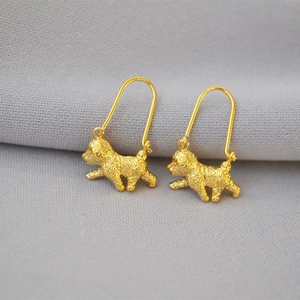 Close-up of gold plated brass earrings in a realistic 3D poodle dog animal shape