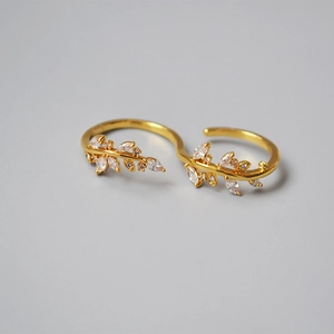 Detail of gold vine double ring with shimmering marquise crystals in leaf design