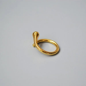 Close-up of a minimalist 18K gold plated brass ring with teardrop detail