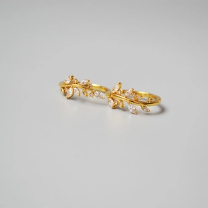 Polished gold olive branch rings set with sparkling marquise zircons in a twin-ring design