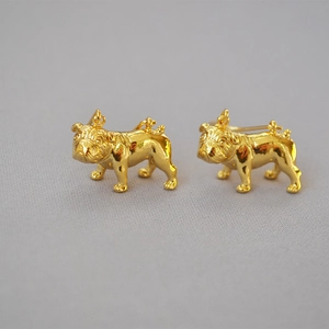 Detailed close-up of 18K gold plated brass bulldog stud earrings with realistic textures