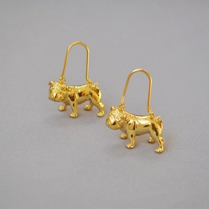 Detailed view of 3D gold-plated bulldog earrings with glossy metallic finish