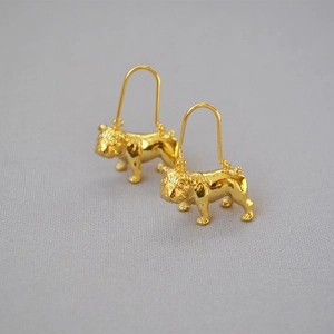 Detailed close-up of 18k gold plated brass bulldog drop earrings with long ear hooks