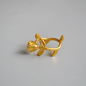 Vintage rose bud adjustable gold ring featuring detailed brass leaves and botanical petals