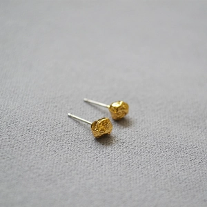 Irregular silver textured lava stone stud earrings with a minimalist artistic style