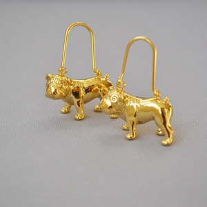 Detailed macro view of 18K gold plated bulldog earrings with 3D animal sculpture relief