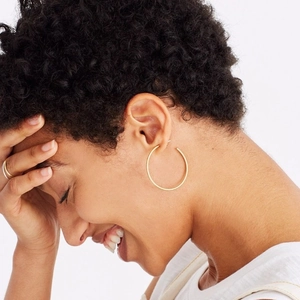 Minimalist gold hoop earrings for women made of brass with a polished circular design