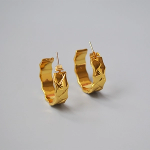 Detail of 18K gold plated brass hoop earrings with 3D geometric lattice pattern