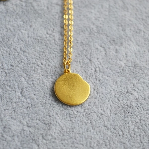 Vintage gold necklace featuring a 12 zodiac relief coin pendant on a delicate fine chain
