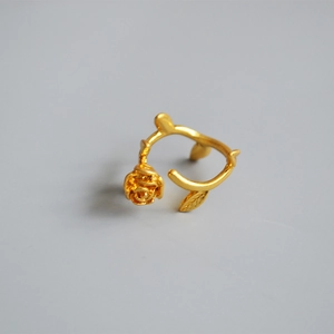 Macro view of vintage gold plated rose flower and leaf adjustable brass ring details