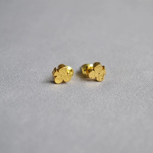 Minimalist gold clover stud earrings with hammered metal texture and 925 silver pins