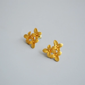 Vintage matte gold floral stud earrings featuring a three-flower cluster design