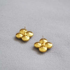 Golden four-leaf clover earrings with pearl inlay and minimalist metallic finish style