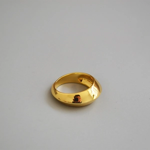 Detail view of a wide gold-plated brass ring with high-polished mirror finish