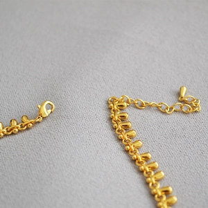 Minimalist gold plated brass teardrop necklace featuring water drop charms and lobster clasp