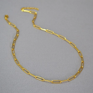Detail of gold paperclip chain necklace with lobster clasp and extension links