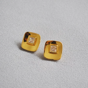 Macro view of square 18K gold plated earrings with sparkling zircon crystals