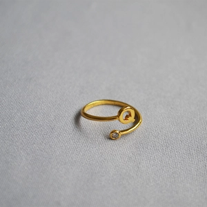 Detailed top view of an adjustable gold letter Q ring with a sparkling round zircon