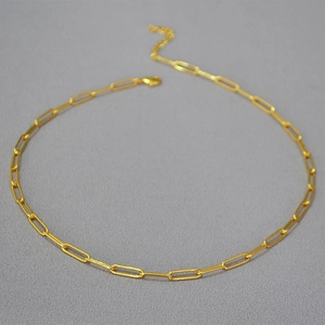 Detail of adjustable gold paperclip chain necklace with lobster clasp closure