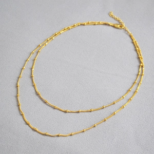 Minimalist double layer brass necklace with 18K gold plating and small beaded details