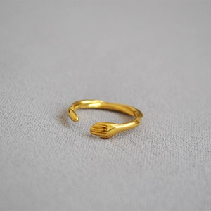Adjustable gold plated brass hug ring featuring a creative minimalist hugging hands design