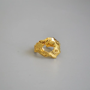 Irregular textured gold lava ring with a vintage molten aesthetic and open band design