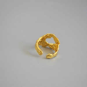 Macro detail of vintage gold irregular rock texture and organic melted metal on ring