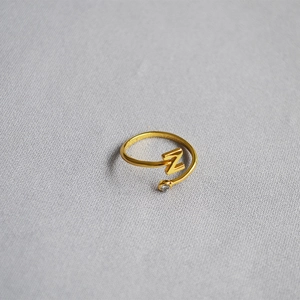 Detail of adjustable gold ring with letter Z initial and sparkling zircon accent