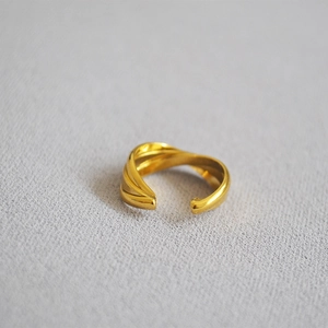 Detailed macro view of the 18K gold plated triple layered intertwined open ring