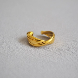 Detailed view of the triple-layered gold-plated brass ring with high-polish finish