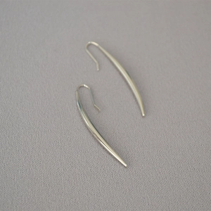 Polished silver-tone brass drop earrings featuring elegant tapered curves and hook style