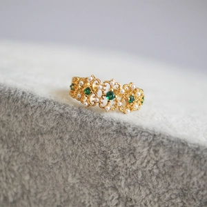 Vintage gold ring with intricate lace carving, emerald gemstones and small white pearls