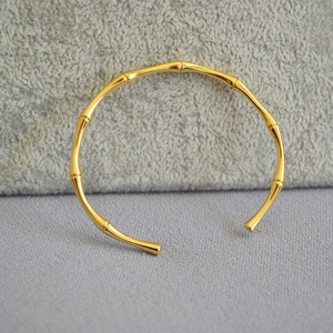 Elegant gold-plated brass bangle with minimalist bamboo style design and open closure