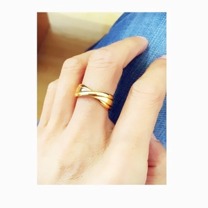 Polished gold-plated triple interlocking band ring for women featuring a minimalist crossover design