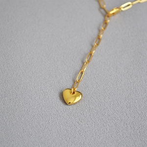 Minimalist gold heart pendant necklace featuring a polished rectangular paperclip link chain