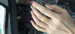 Detailed view of layered gold wire-wrapped ring with pearl and hammer texture