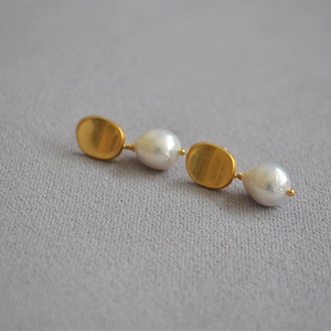 Vintage matte gold baroque freshwater pearl drop earrings on grey textured fabric