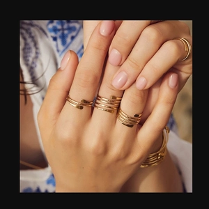 Detail of handcrafted gold multi-layer wrap ring and matching spiral cuff bracelet